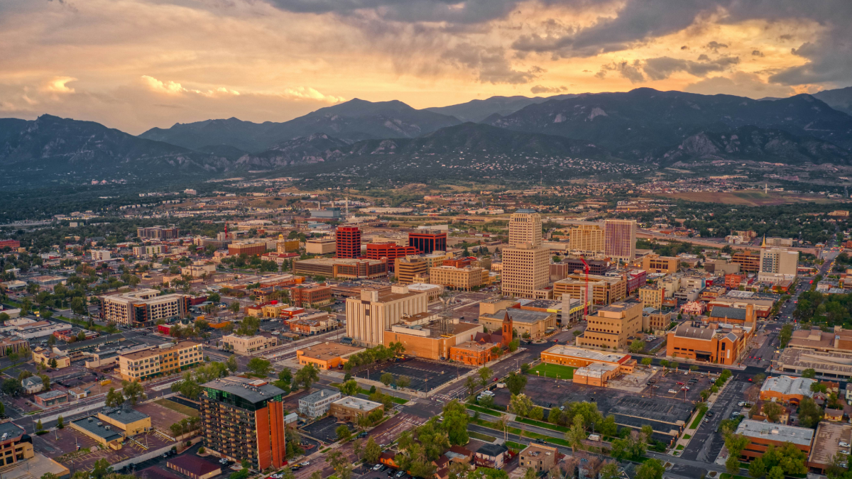 Luxury car service from Colorado Springs to Denver International Airport with mountain landscape background