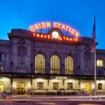 Luxury Denver airport shuttle van arriving at Union Station with passengers boarding comfortably